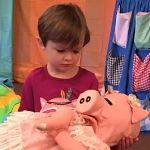 Boy holding Pinky Poo Pig puppet
